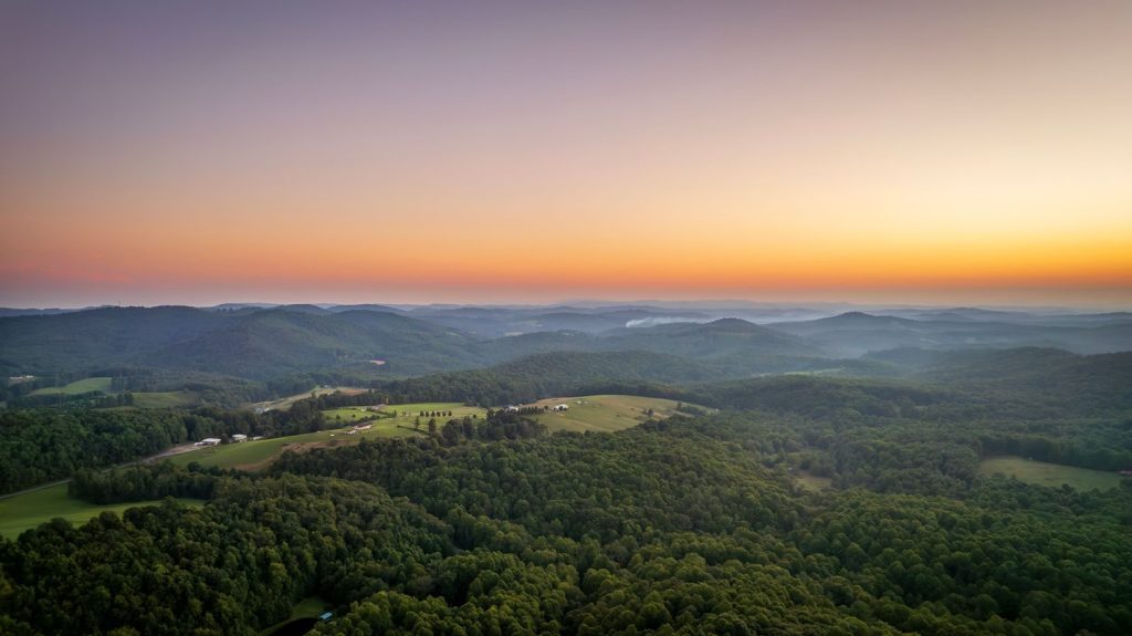 Aerial landscape of rolling hills in Meadows of Dan, Virginia at sunset.